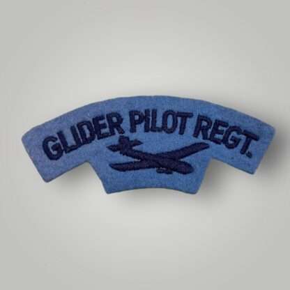 A British Pilot Regiment shoulder title post war, machine embroidered in dark blue thread on thread on pale blue woollen backing.