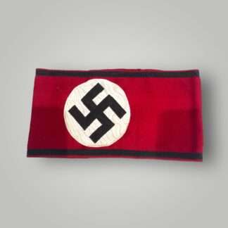 A rare original Allgemeine SS Armband With RZM Label 1933, three piece construction on red wool with black tress bordered running along the whole length on the armband above and below.