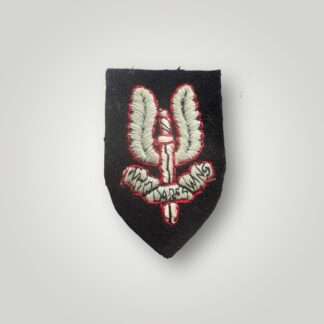 A genuine Special Air Service beret badge for other ranks, hand-embroidered in Oxford blue thread outlined in red thread on a black padded shield.