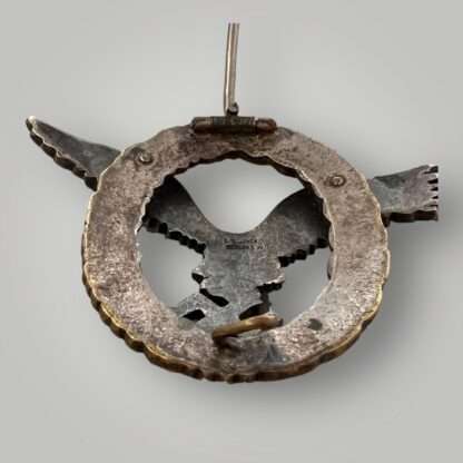 Reverse image of an original Luftwaffe Pilots Badge By Juncker J2, two part construction made from tombak wuth barrel hinge and wire catch.