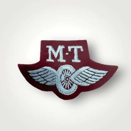 An original British Airborne WW2 Motor Transport proficiency badge, machine embroidered in pale blue thread on maroon.