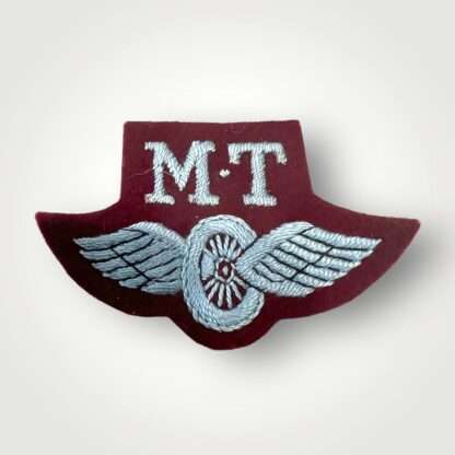 An original British Airborne WW2 Motor Transport proficiency badge, machine embroidered in pale blue thread on maroon.