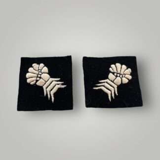A orginal set of British WW2 6th Armoured Division formation badges, machine embroidered depicting a clenched mailed gauntlet in white on a black woollen square.