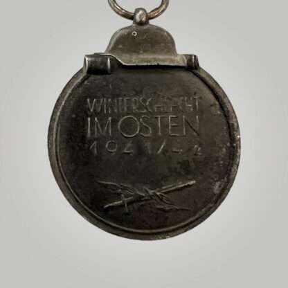 An original Eastern Front Medal, constructed in zinc with nice long ribbon. The suspension ring is stamped with PZK code "19" for E. Ferd. Wiedmann.