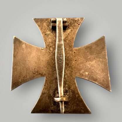 Reverse image of an Iron Cross EK1 marked L/58, multi-piece construction with a magnetic blackened iron core.