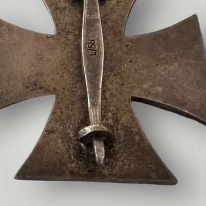 Reverse image of an Iron Cross EK1 marked L/58, multi-piece construction with a magnetic blackened iron core.