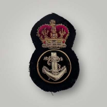 A British Royal Navy Petty QEII Officer's cap badge post war, hand embroidered in bullion wire and felt.