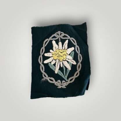 An original Heer Gebirgsjager Edelweiss mountain troops sleeve badge, flat woven BeVo construction on green backing