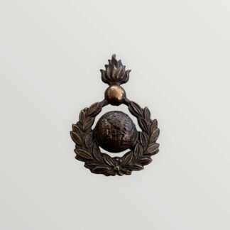 A Royal Marines Artillery Sergeants Forage Cap Badge 1921 - 1923, constructed in brass. The badge depicts the classic Royal Marines Globe surrounded by a laurel wreath, surmounted by a grenade fired proper.