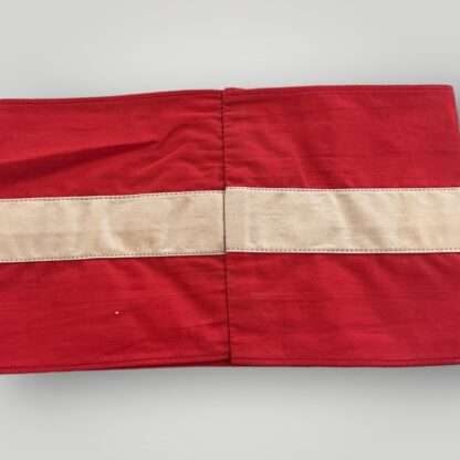 An original Hitler Youth cloth armband, two part construction in red cotton overlaid by a white cotton diamond bearing a black swastika