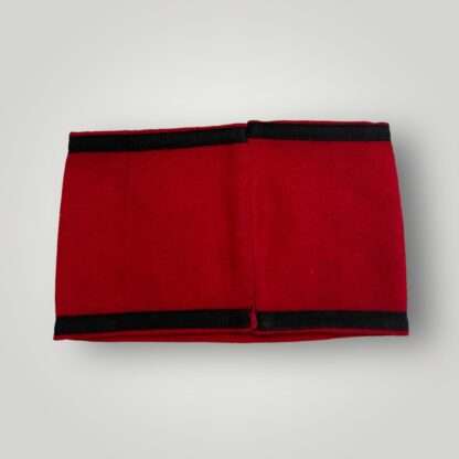 An Allgemeine SS Armband with RZM Label, three piece construction on red wool with black tress bordered running along the whole length on the armband above and below.