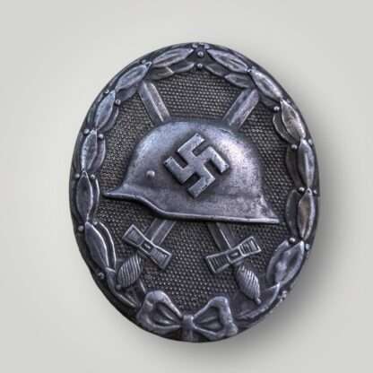 A WW2 German wound badge in silver by Juncker, constructed in tombac with nice silver wash and patina.