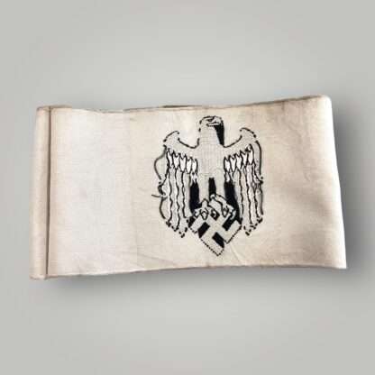 Reverse image of a Heer Recruitment armband, constructed in thin white cotton machine embroidered.