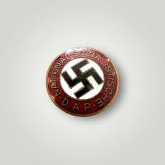 An early NSDAP Party Badge By Schwertner & Cie, Graz, Eggenberg, constructed in red, white, black, and gold enamel.