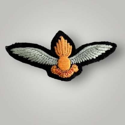 An original British Army Royal Artillery Pilots Wings post war, machine embroidered in yellow, red, sky blue thread on dark blue woolllen backing.