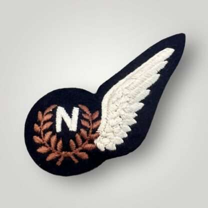 An original British WW2 RAF Navigator Brevet Badge, machine embroidered in white and brown thread on black backing padded.