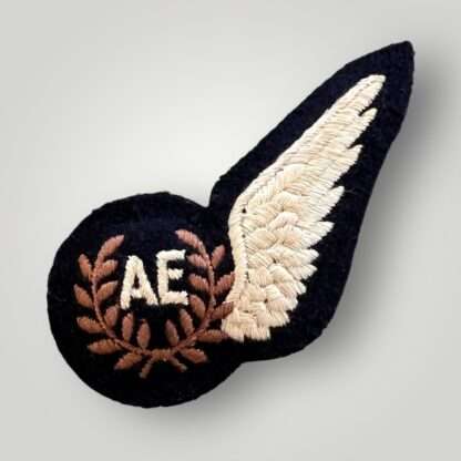 An original British WW2 RAF Air Electronics Brevet Badge, machine embroidered in white, bronze thread on black backing padded.