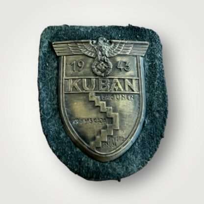 An original Heer Kuban shield, die stamped construction in bronze complete with field grey woollen backing.