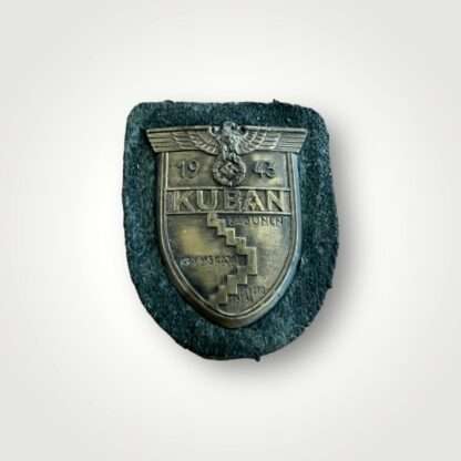 An original Heer Kuban shield, die stamped construction in bronze complete with field grey woollen backing.