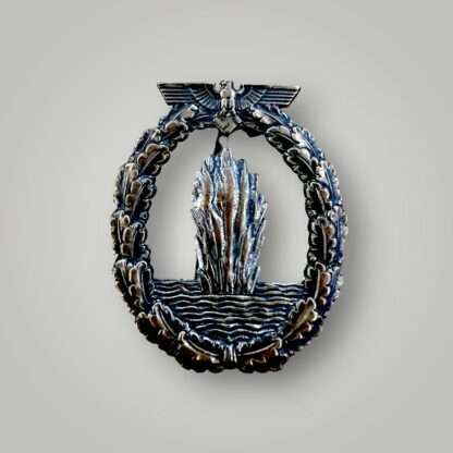 A Kriegsmarine Minesweepers War Badge by Juncker, constructed in tombac with nice patina with nice silver finish on the waves and water plume.