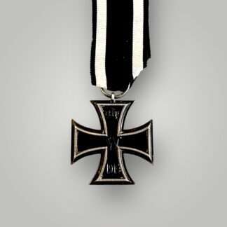 A WW1 Iron Cross 1914 2nd Class by S.W., three-part construction with magnetic iron core complete with original ribbon.