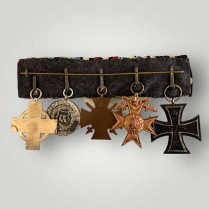 Reverse image of a WW1 German swing mounted medal bar consisting of the Iron Cross 2nd Class 1914, Bavarian Military Merit Cross 3rd Class, Honour Cross without swords 1914 – 1918 for combatants, Bavarian Military Long Service Award 3rd Class, complete with WW2 Fire Brigade Honour medal.