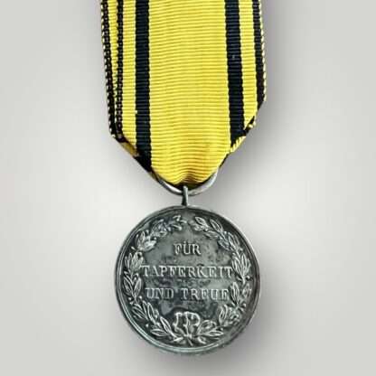 Reverse image of a Wurttemberg Silver Military Merit Medal (Württemberg Militärverdienstmedaille) complete with original ribbon.