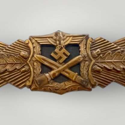 An authentic WW2 German Close Combat Clasp Bronze by A.G. M.u.K. Gablonz 1st pattern, constructed in zink with 90% of the bronze finish intact.