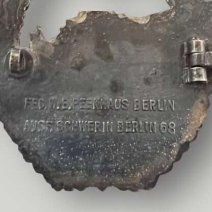 Reverse image of an original Kriegsmarine E-Boat Badge by Schwerin 2nd Pattern, constructed in zinc, stamped with makers mark "FEC W E PEEKHAUS BERLIN AUSF SCHWERIN BERLIN 68".