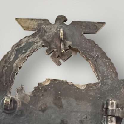 Reverse image of an original Kriegsmarine E-Boat Badge by Schwerin 2nd Pattern, constructed in zinc, stamped with makers mark "FEC W E PEEKHAUS BERLIN AUSF SCHWERIN BERLIN 68".