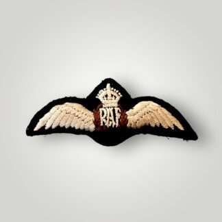 A Royal Air Force WW2 Paddeed Pilot Wings, embroidered pair of outstretched wings supporting a central laurel wreath encircling the RAF monogram with above a King's crown, the wings, monogram, and crown in cream, and the wreath in brown on black padded backing.