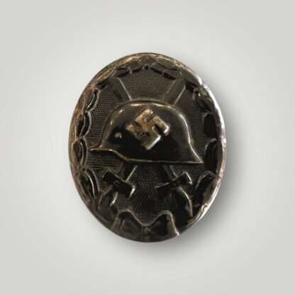 An original WW2 German Wound Badge Black 1939 by Eduard Hahn, die-stamped in steel with nice factory paint finish.