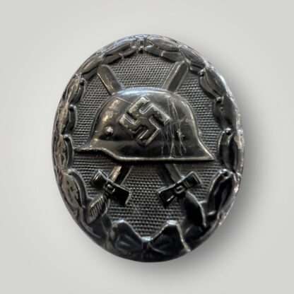 An original WW2 German Wound Badge Black 1939 by Eduard Hahn, die-stamped in steel with nice factory paint finish.