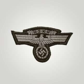 An NSKK sleeve eagle, machine embroidered flat wire bevo construction in silver thread on brown backing. The obverse of the insignia depicts a longed winged eagle used by National Socialist Motor Corp with a scroll above with the organisations initials.