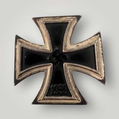 An original Iron Cross 1st Class By Wächtler & Lange, with a nice blackened magnetic iron core and ribbed border, with a raised swastika in the centre and institution date 1939 below.