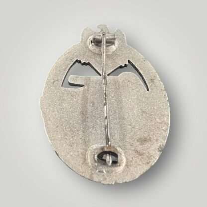 Reverse image of an original mid to late war panzer assault badge silver with crimped hinge and catch.