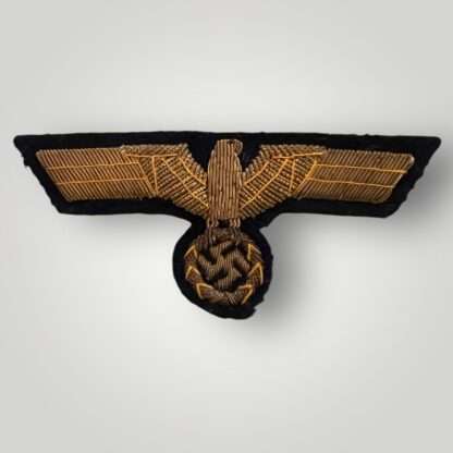 A Kriegsmarine Officer's bullion breast eagle, constructed with gold bullion thread on dark blue woollen backing.