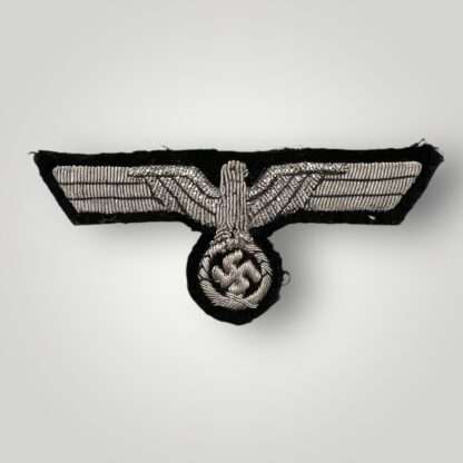 A WW2 German Heer (Army) bullion officer's tunic breast eagle, hand-embroidered in silver bullion wire interlaced with black thread on dark green woollen backing.