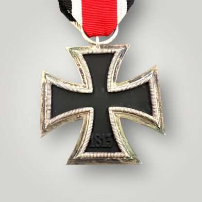 Reverse image of WW2 German Iron Cross 2nd class medal by Eugen Gauss, two part construction with magnetic iron core with original ribbon. The obverse of the medal has beautiful patina with nice silver plated frame with original factory paint finish.