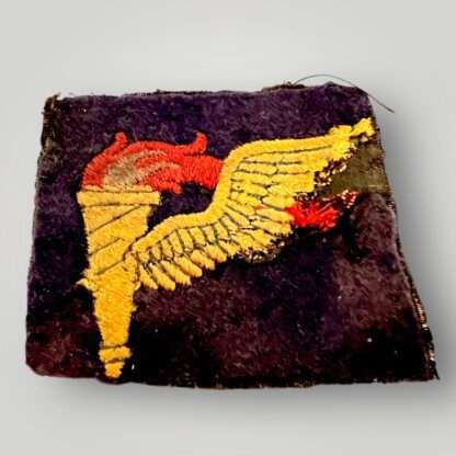 A rare US WW2 Pathfinder Badge, machine embroidered in golden yellow, light blue and red thread on dark purple/blue woollen backing.