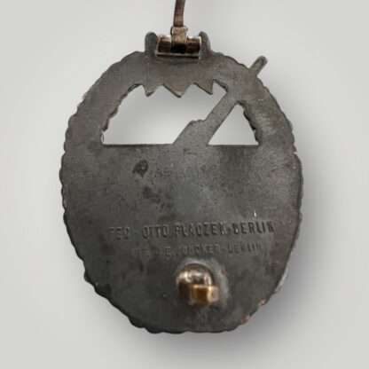 Reverse image of an original Kriegsmarine Coastal artillery badge with C.E. Juncker makers mark.