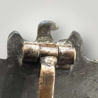 Reverse image of an original Kriegsmarine Coastal artillery badge with barrell hinge C.E. Juncker makers mark.