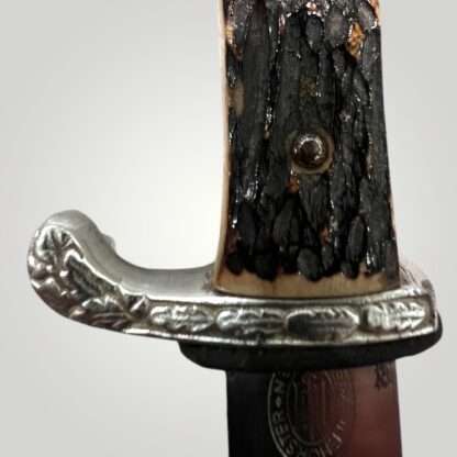 A close of a German WW2 Land Customs Bayonet stag grip by Horster.