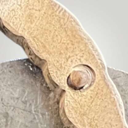 A close up image of a rivet on a Luftwaffe Observer's Badge by Assmann, two-part construction in tombak.