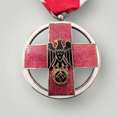 A rare German Cross Of Honor Medal 1937-1939, constructed in red, white, black, and gold enamel with a silver supension ring and ribbon.