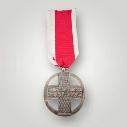 Reverse image of a German Cross Of Honor Medal 1937-1939, with the inscription "Für Verdienste um das Deutsche Rote Kreuz" (For Services To The Red Cross).