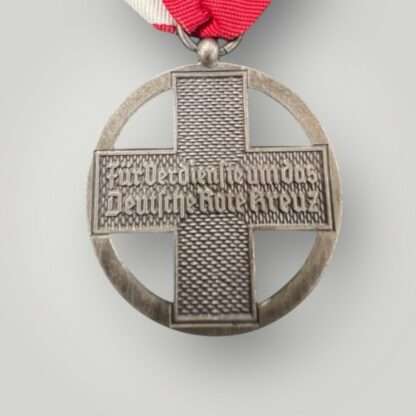 Reverse image of a German Cross Of Honor Medal 1937-1939, with the inscription "Für Verdienste um das Deutsche Rote Kreuz" (For Services To The Red Cross).