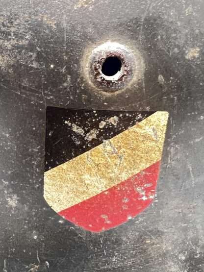 A close up image of a air vent and National tri-colour decal on a German WW2 M35 Luftwaffe helmet.