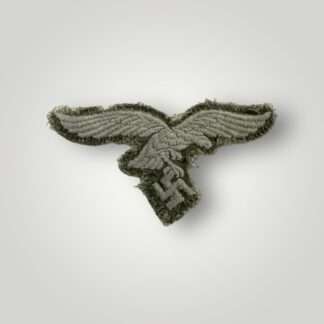 A WW2 German Luftwaffe EM/NCOs embroidered breast eagle for HBT tunic, with silver grey weave on green twill stiching.