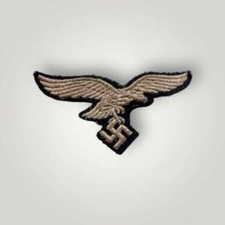 A German WW2 Luftwaffe EM/NCOs embroidered breast eagle, machine embroidered in silver thread on blue woolen backing.